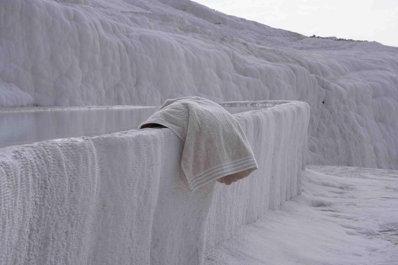 A piece of Minoa towel hanging on the edge of a rock 