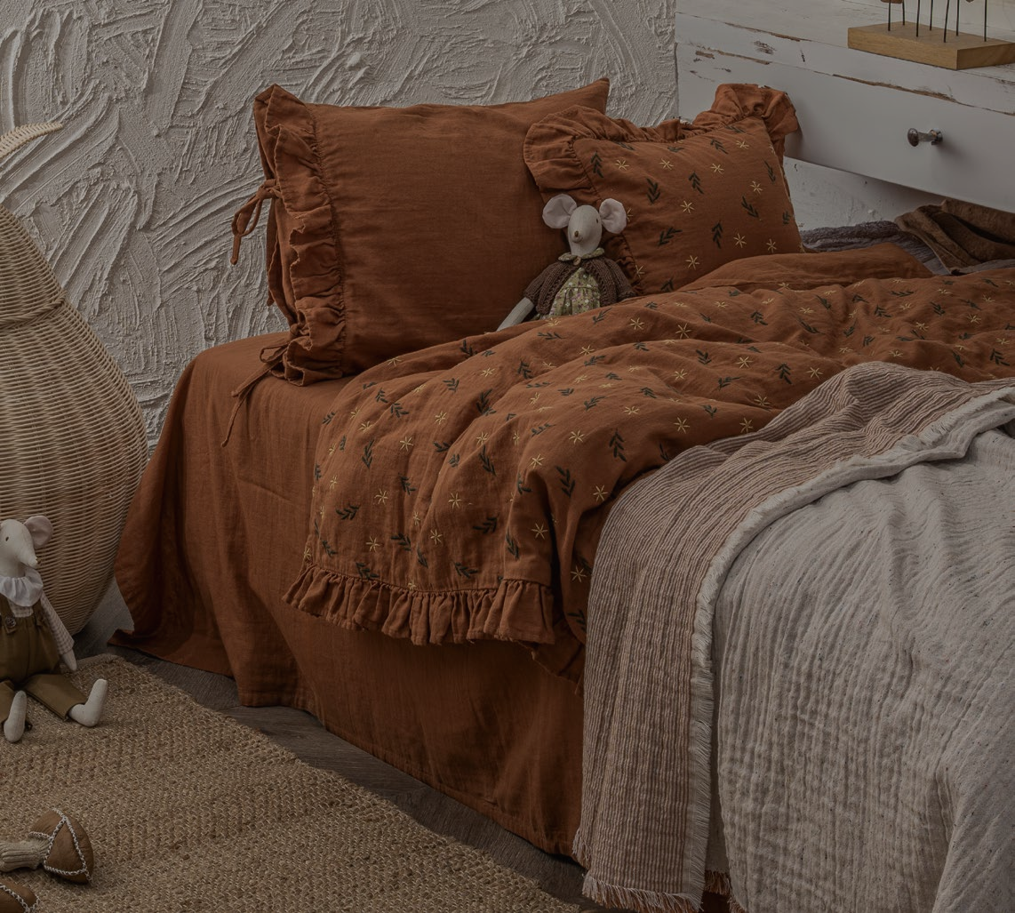 A cute mouse toy laying on Minoa's bedding sets