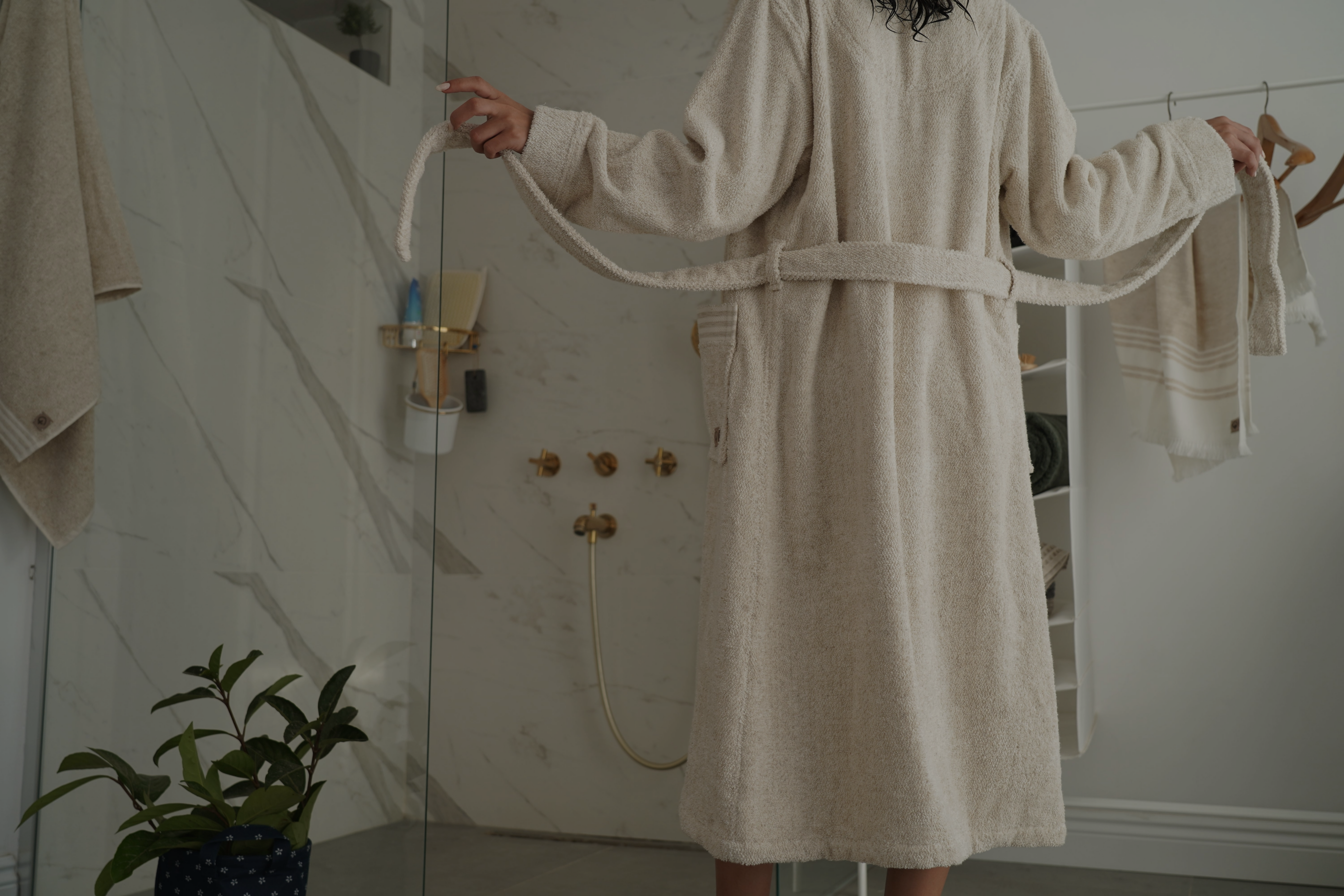 this is a lady untying her bath robes and prepared to get showered