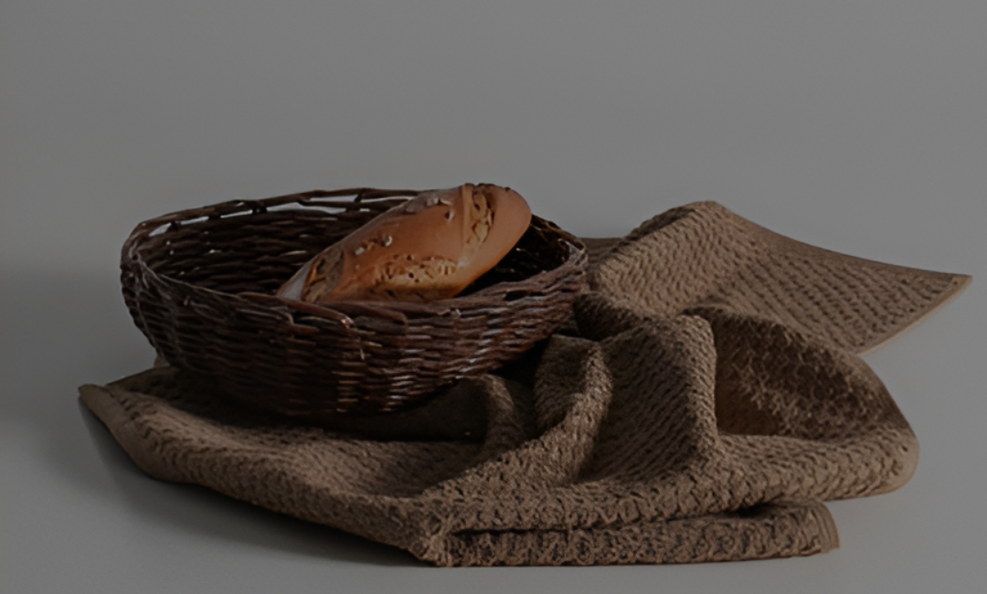 Minoa's organic lifestyle kitchen towel with fresh bread beside.