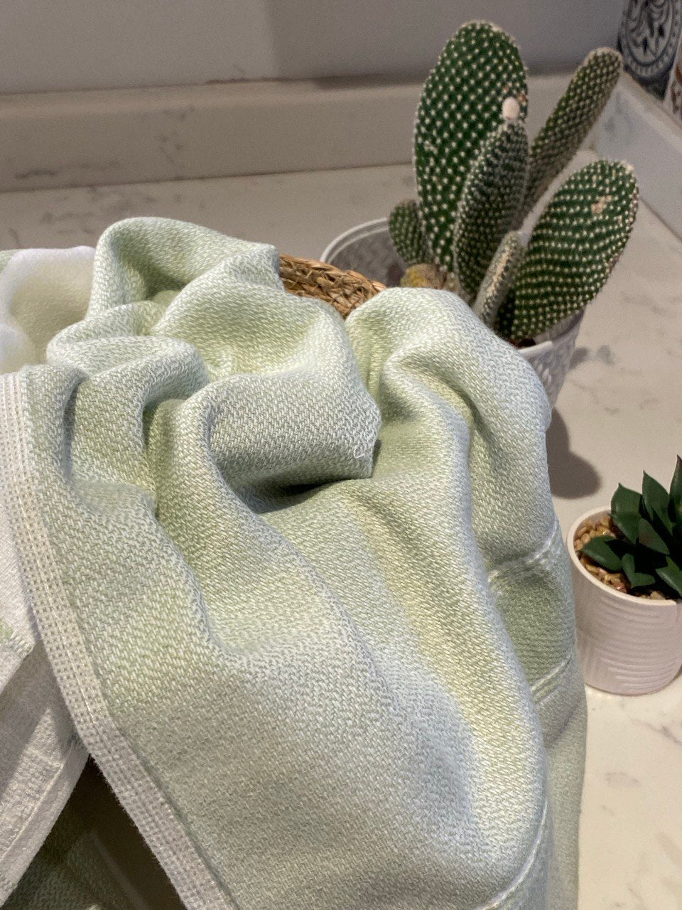 Lime towel in a basket on a kitchen counter