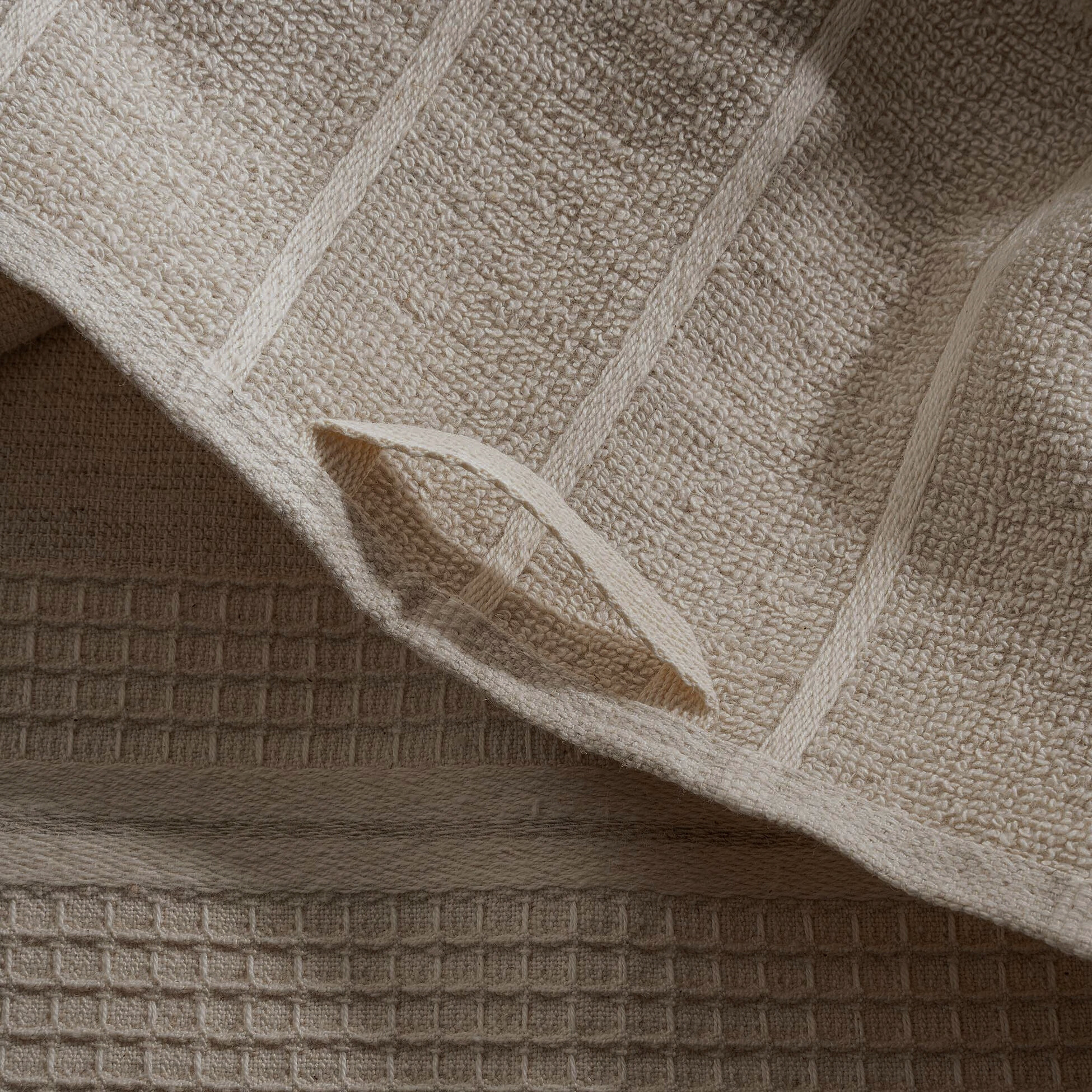 Arden Hemp and Organic Cotton Bath Towel with tassels in sand and white showcasing its soft texture natural color and delicate tassel details as a luxury bath towel and organic bath towel