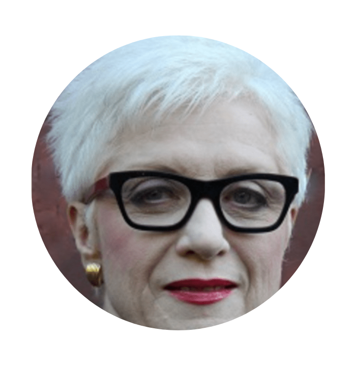 Woman wearing black glasses with gold earrings 