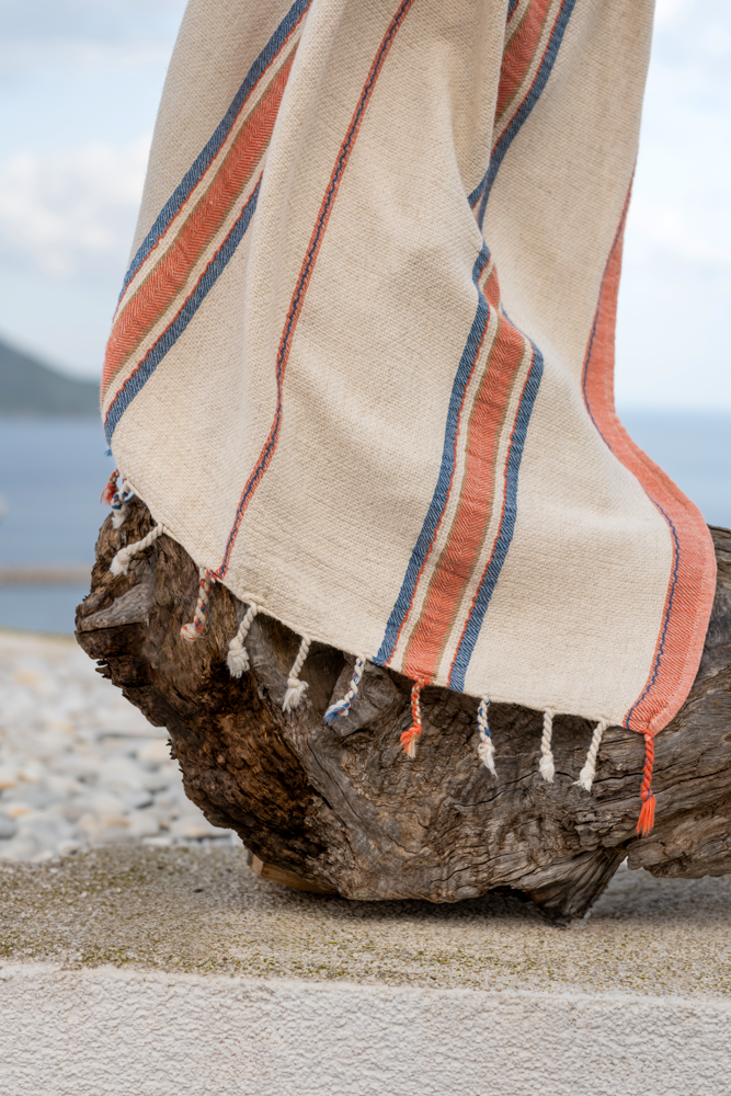 Luxury, sustainable Elba Turkish Towel beside the beach along with a rock