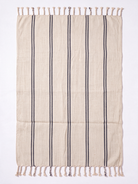 A rectangular beige woven towel with vertical dark gray stripes and fringed tassels on the top and bottom edges, photographed flat against a white background.