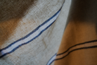 Close up of blue and white Anakao 215 gram Aegean Cotton and Linen Turkish towel showcasing its soft texture and quality as an organic bath towel