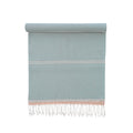 Light blue towel with white stripes and fringes on a white background