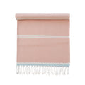 Pink towel with white stripes and fringes on a white background