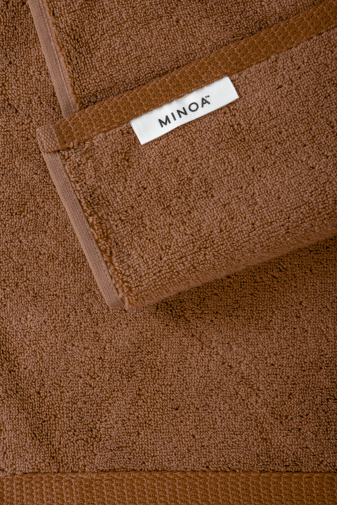 Close-up of Cinnamon Charm Plush Lite Aegean Cotton luxury organic bath towels showcasing warm cinnamon hue and soft plush texture
