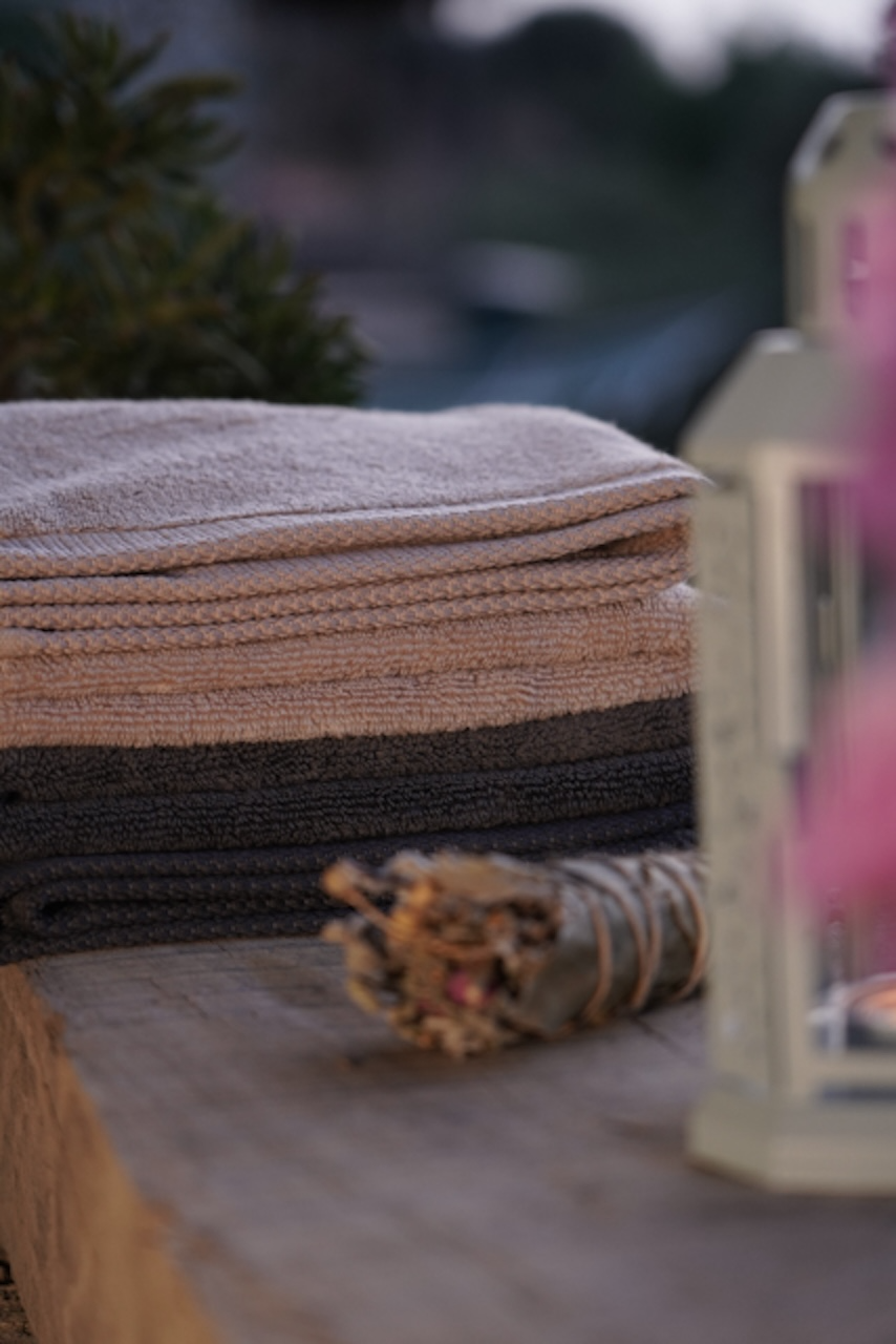 Plush Lite 500-Gram Aegean Cotton Large Organic Bath Towels in Moonlight Pearl and Charcoal Embrace, neatly folded to highlight their soft texture and elegant tones