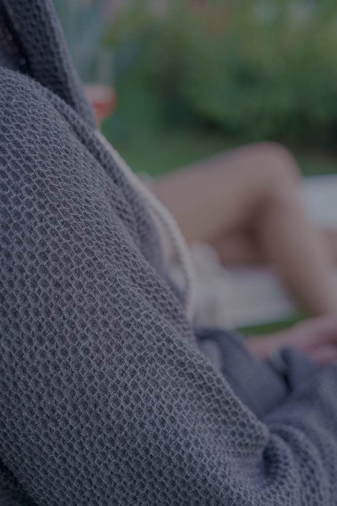 A close up shot of Minoa's Naia Panama Weave Mens Robe showcasing its sophisticated, delicately weaved texture