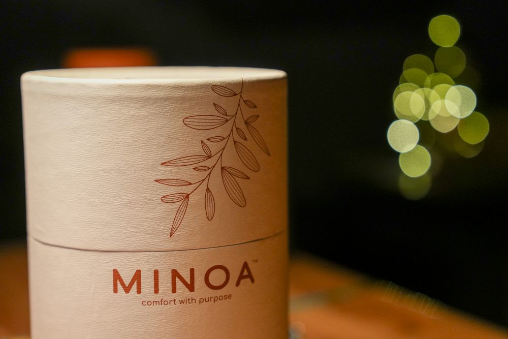 Plush Lite 500-Gram Aegean Cotton Large Bath & Hand Towel Set placed in a white luxury cylinder case