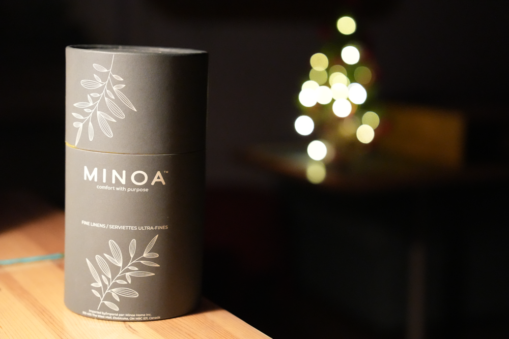 Plush Lite 500-Gram Aegean Cotton Large Bath & Hand Towel Set placed in a dark navy green luxury cylinder case