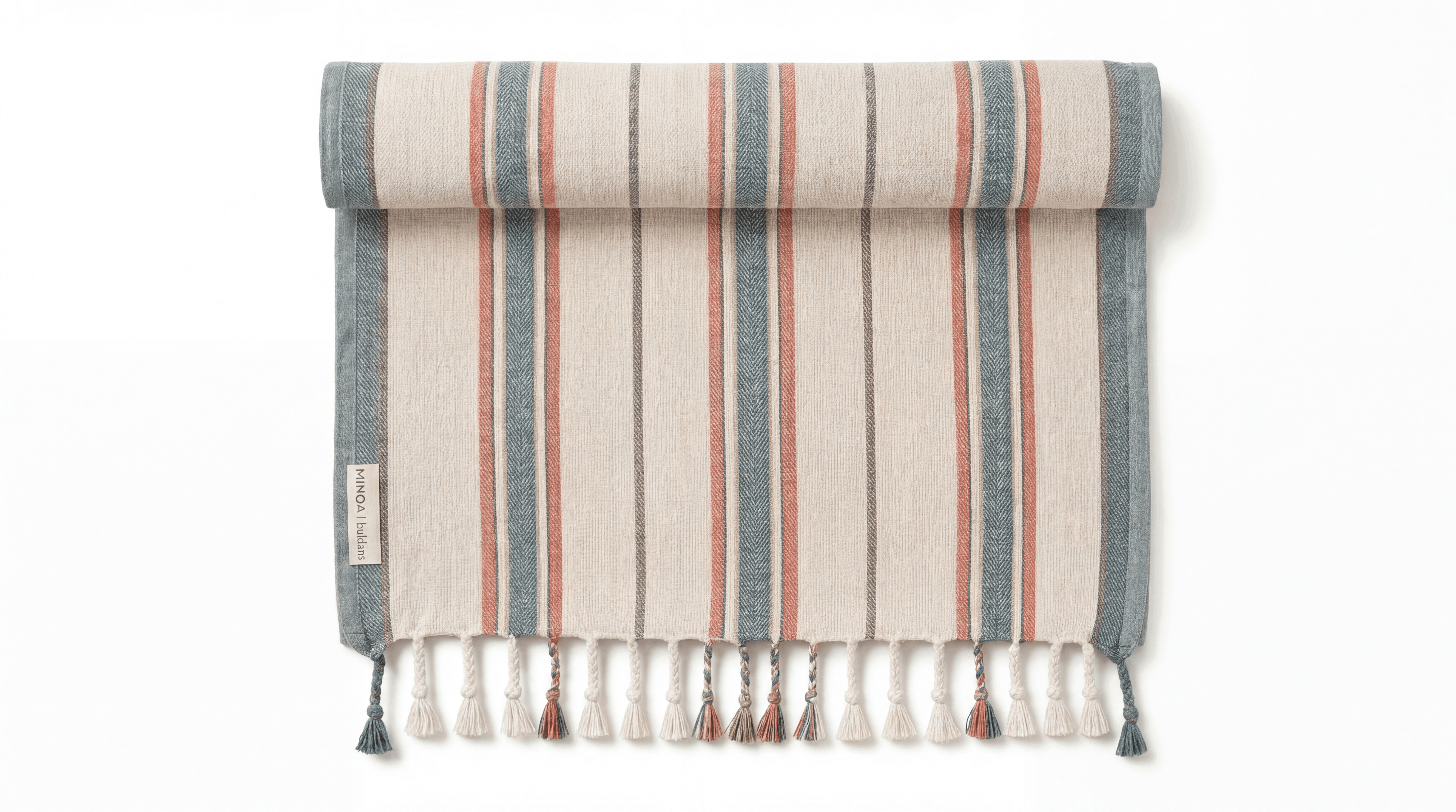 A rolled-up woven towel with vertical stripes in muted blue-gray, terracotta, and cream, finished with fringe tassels along the bottom edge, shown on a plain white background.