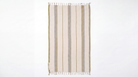 A rectangular woven towel with vertical stripes in beige, brown, and muted olive tones, finished with white fringe on the top and bottom edges, shown flat against a plain white background.