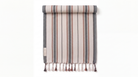 A striped towel hanging flat against a white background, featuring vertical bands in beige, gray, and muted red-brown, with tassels along the bottom edge.