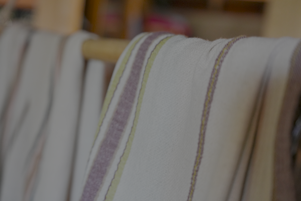 Two organic luxury bath towels from the Elba Turkish collection hanging on the same cloth hanger
