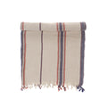 Folded towel with striped pattern and tassels on a white background
