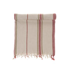 Striped, red & green, towel with fringes on a white background