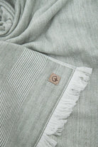Close-up of the three-piece Hasna Organic Aegean Cotton and Linen Bath Set in Pine Breeze, highlighting the rich color, soft texture, and detailed craftsmanship