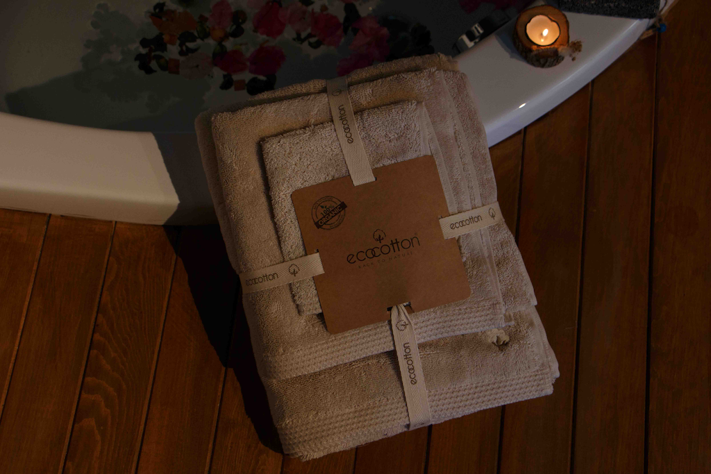 Jasper 600-gram organic Aegean cotton luxury bath, hand, and washcloth towel set in packaging, displayed with a spa background, highlighting soft texture, elegance, and sustainable luxury