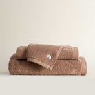 Jasper 600-gram organic Aegean cotton luxury bath, hand, and washcloth towels in Amber Amour, showcasing soft plush texture, rich tone, and luxurious fabric