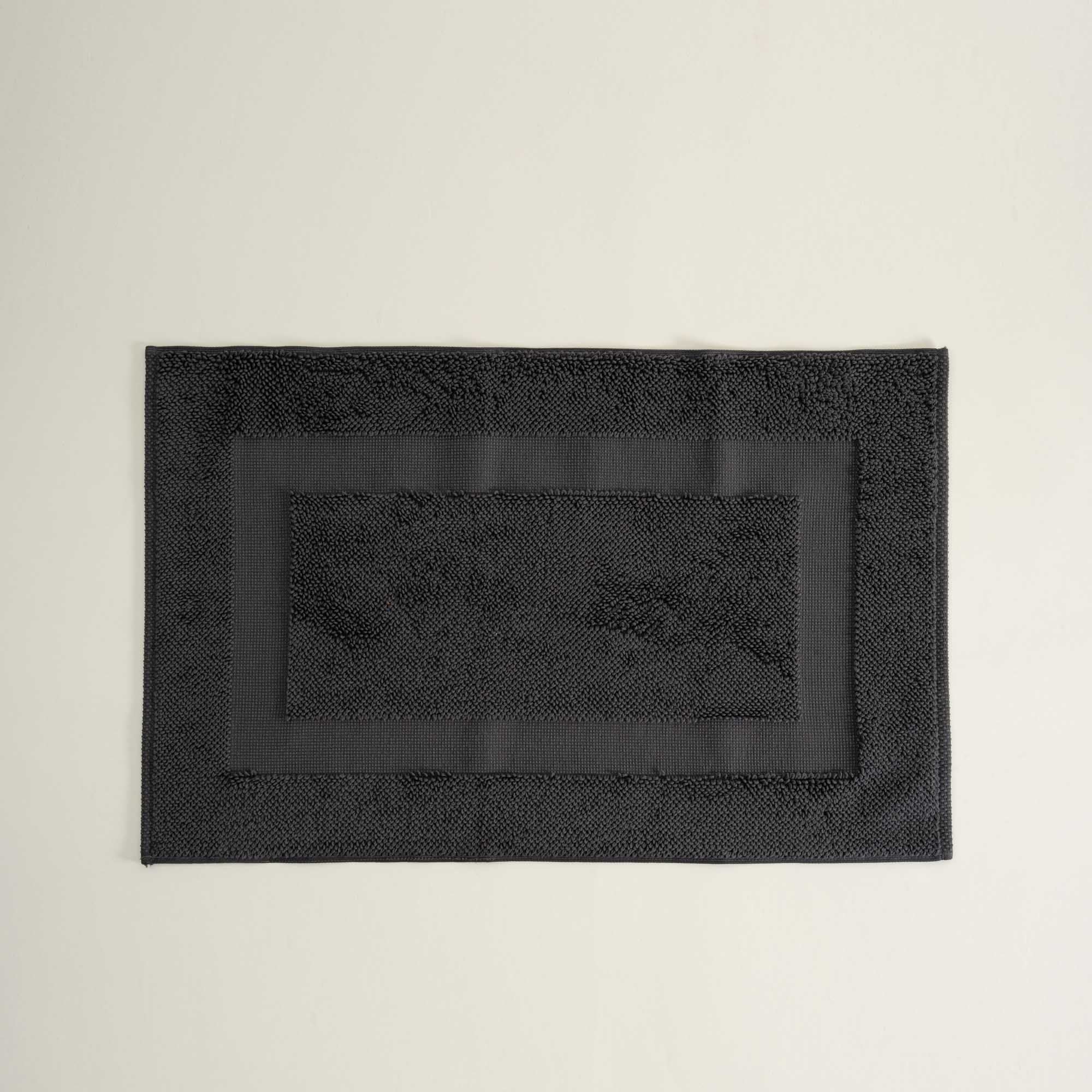 Kaia Aegean Cotton Bath Mat in Charcoal Charm, neatly placed, showing its rich colour, soft texture, and refined design