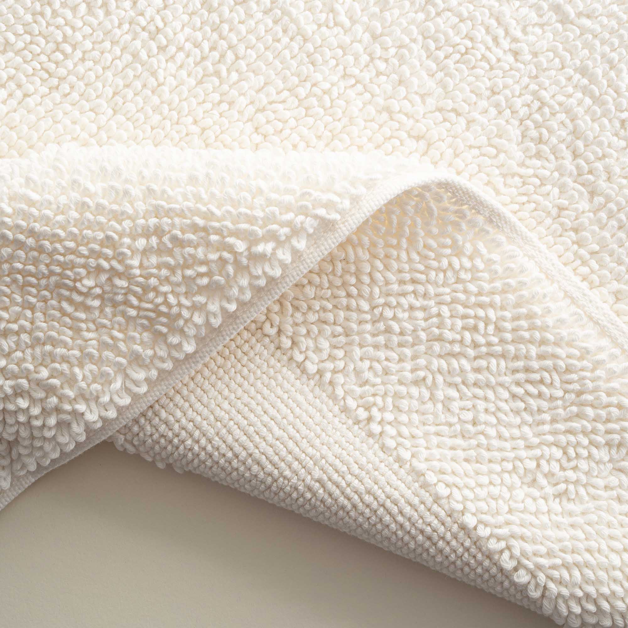 Close-up of the folded Kaia Aegean Cotton Bath Mat in Pearl Petal, showing its plush texture, soft colour, and quality finish