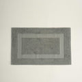Gray bath mat on a light gray background