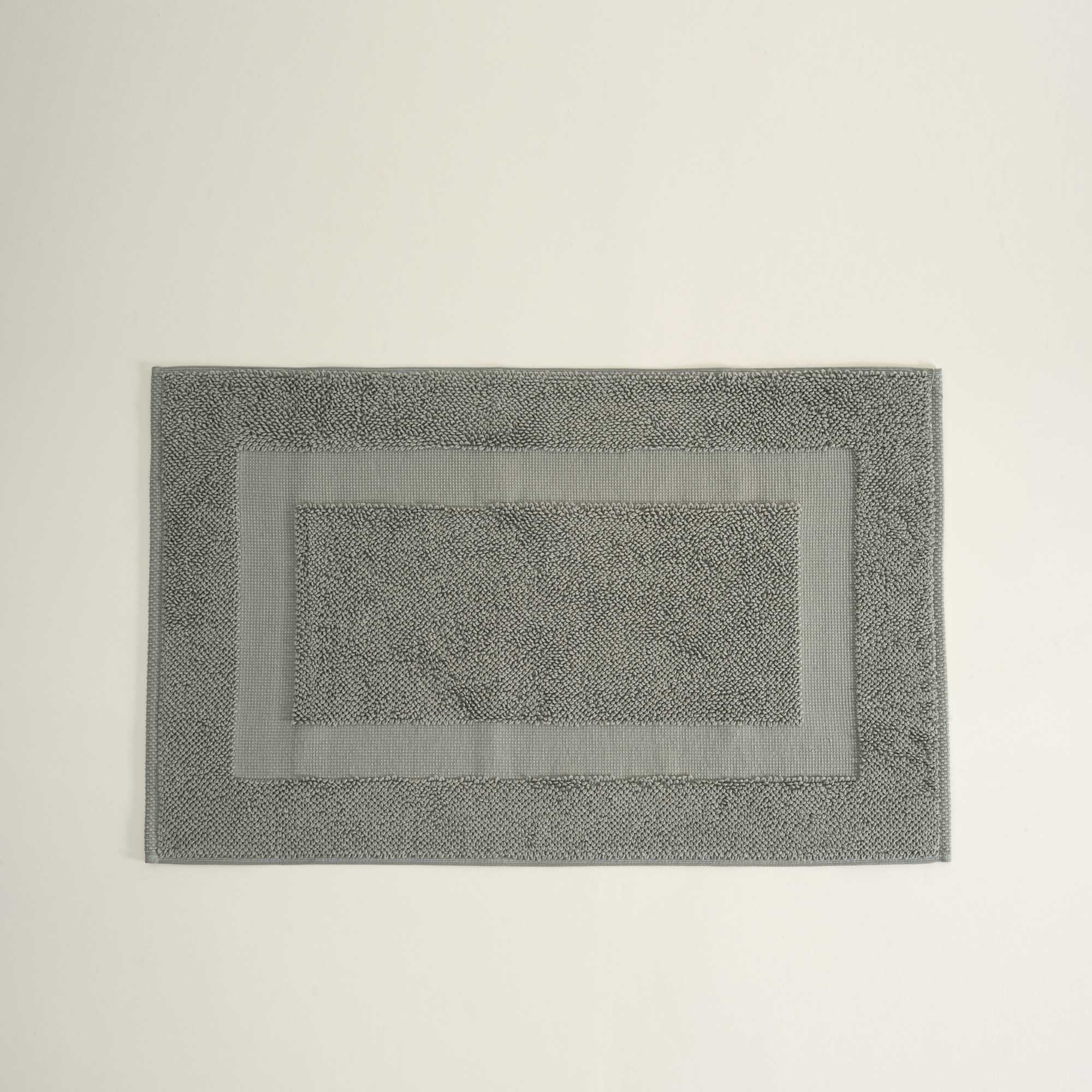 Gray bath mat on a light gray background