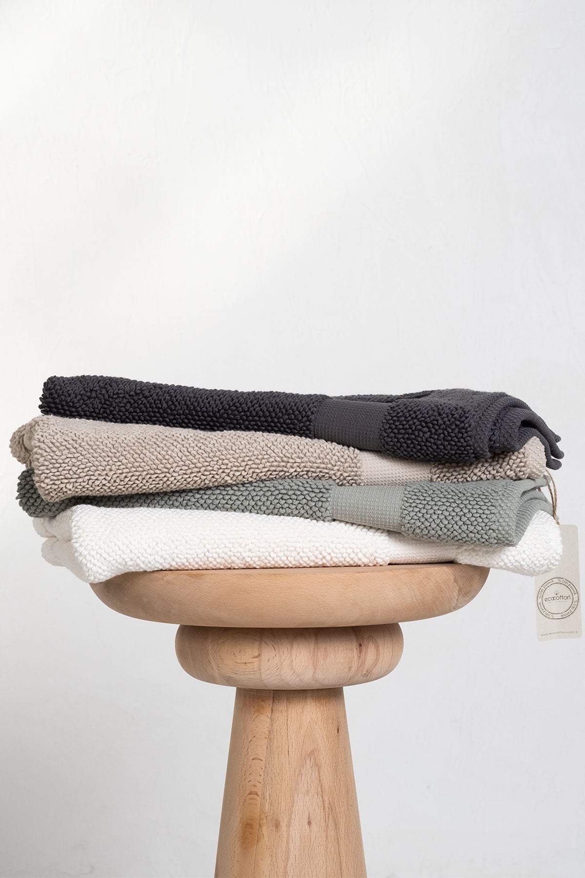 Kaia Aegean Cotton Bath Mats displayed in four colours—Charcoal Charm, Whispering Sands, Meadow Sage, and Pearl Petal—showcasing their soft texture, elegant tones, and premium quality