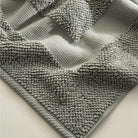 Close-up of the Kaia Aegean Cotton Bath Mat in Meadow Sage, showing its plush texture, natural tone, and high-quality finish