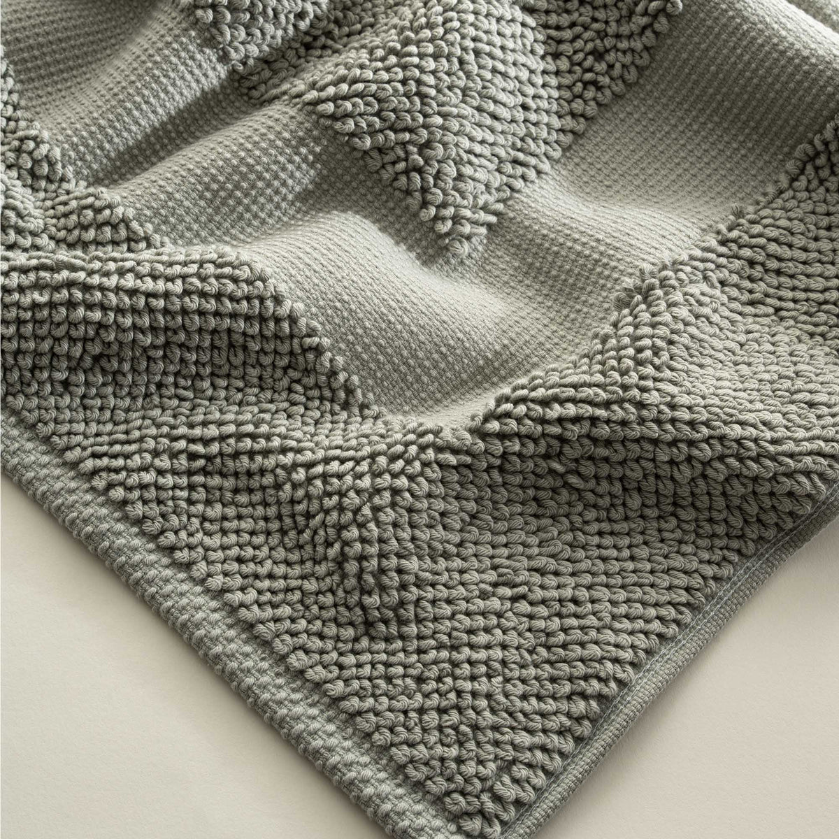 Close-up of the Kaia Aegean Cotton Bath Mat in Meadow Sage, showing its plush texture, natural tone, and high-quality finish