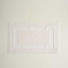 Folded Kaia Aegean Cotton Bath Mat in Pearl Petal, showing its soft texture, gentle hue, and refined craftsmanship