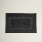 Kaia Aegean Cotton Bath Mat in Charcoal Charm, neatly placed, showing its rich colour, soft texture, and refined design