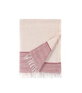 Beige and pink woven towel with fringes on a white background