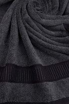 Close-up of a dark gray towel with textured border