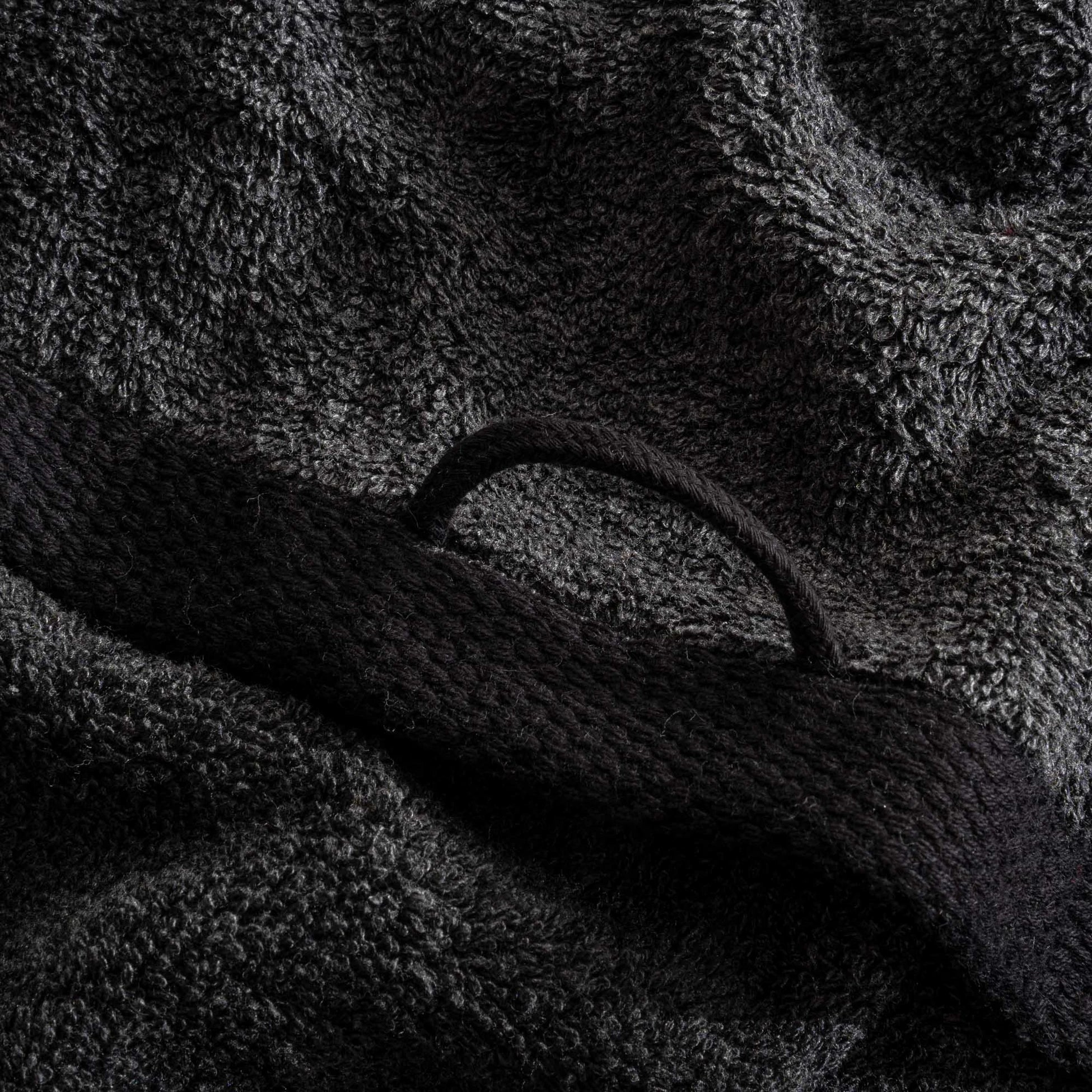 Close-up of a textured black towel with a handle