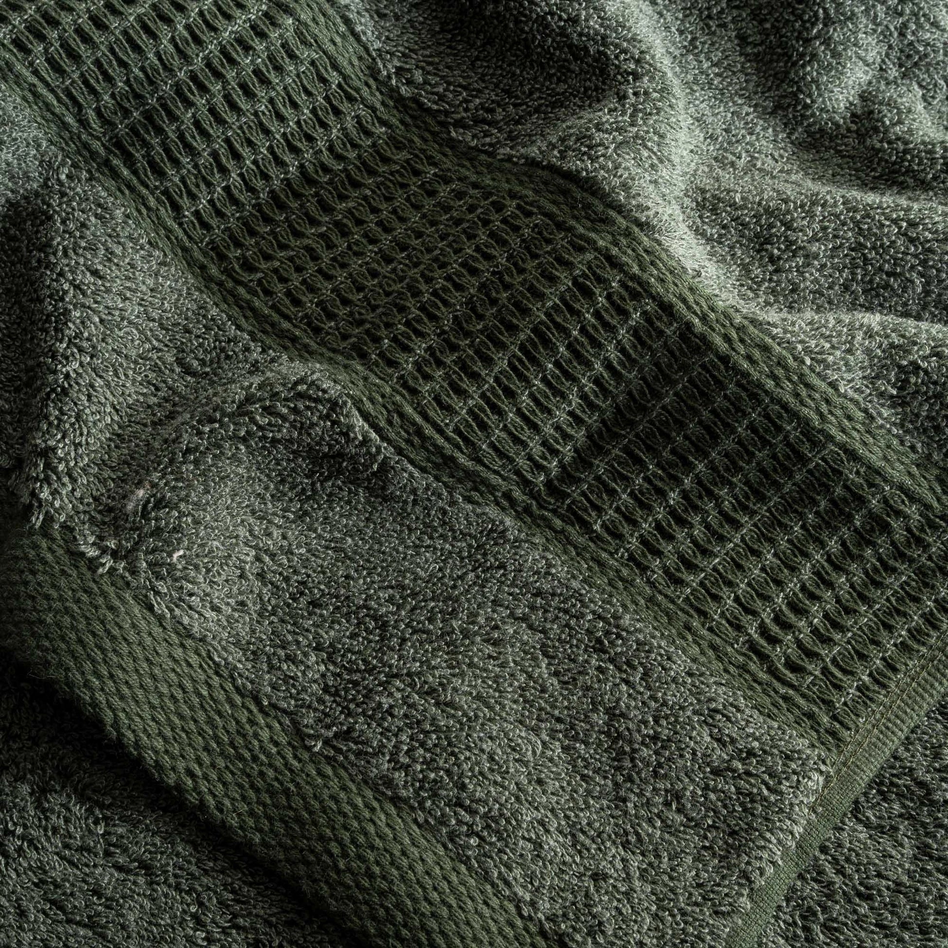 Close-up of green textured towel with a patterned design