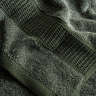 Close-up of green textured towel with a patterned design