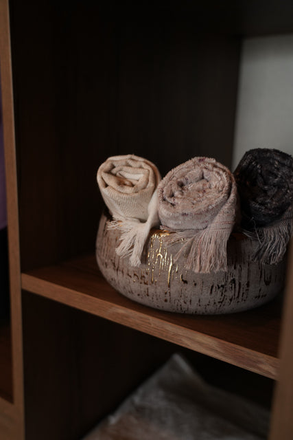 Maia organic bath towels set by Minoa USA Canada, sustainably made from organic cotton and viscose, rolled up neatly in a basket for a luxury bath presentation