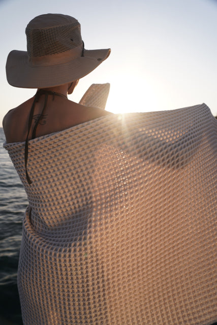 Woman wrapped in Yummy Vanilla Seren organic cotton waffle luxury bath towel