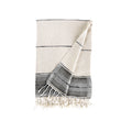White towel with black stripes and fringes on a white background