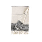 White towel with black stripes and fringes on a white background