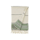 Beige and green towel with fringes on a white background