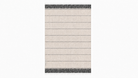 A rectangular woven towel with a light beige body, horizontal dark gray stripes, and dark gray fringe detailing on the top and bottom edges, shown against a plain white background.
