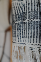 Close-up of a towel fabric with fringes on a blurred background
