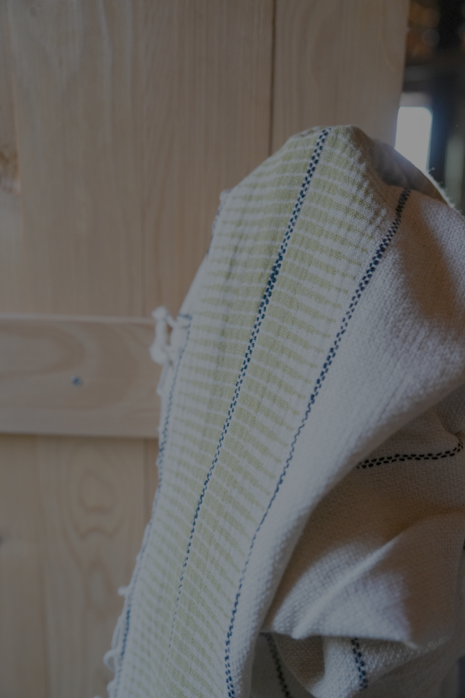 Textured towel with blue stripes on a wooden surface