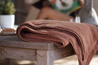 Brown towel on a wooden table with a blurred background