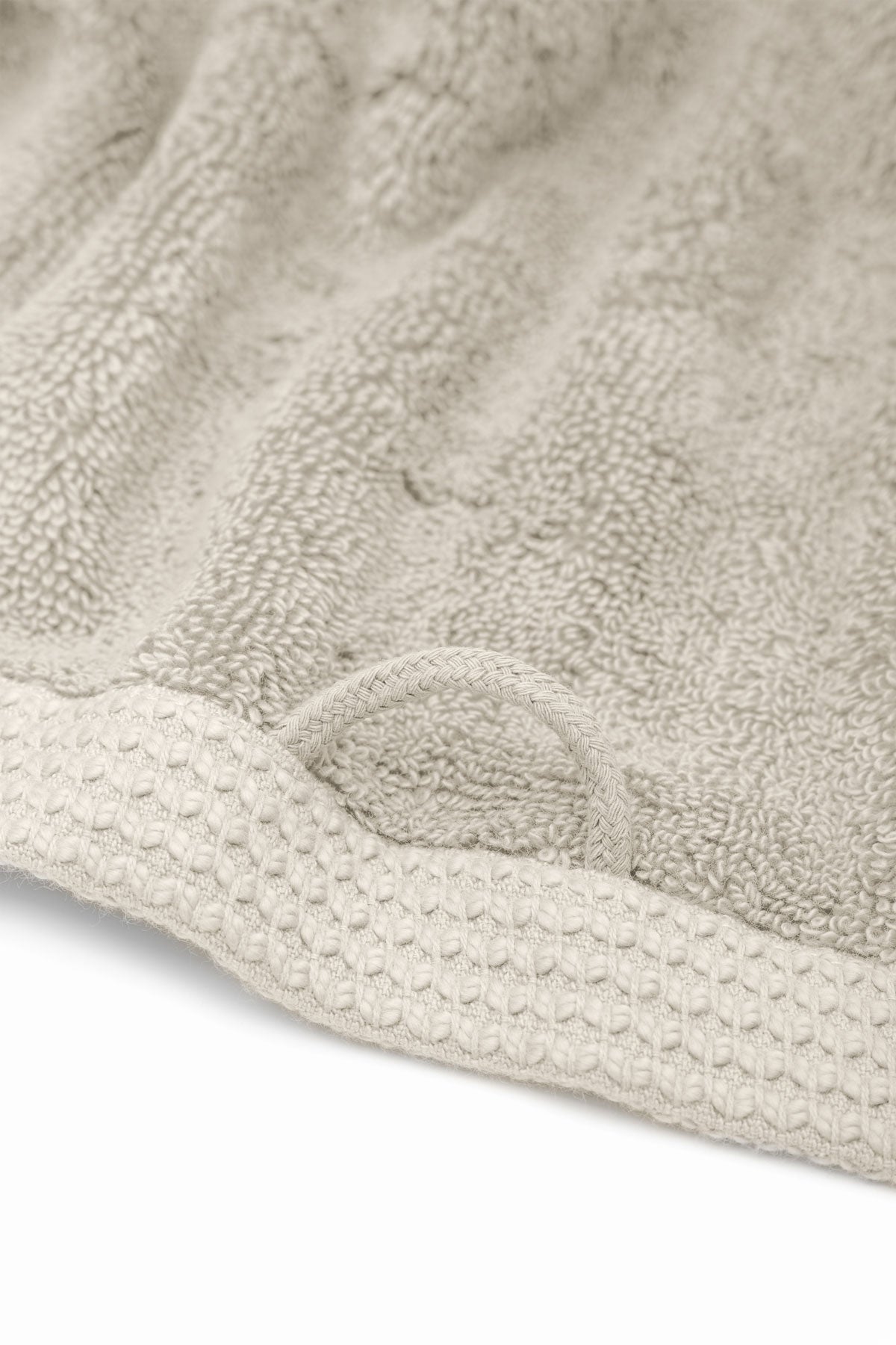 Jasper 600-gram organic Aegean cotton luxury bath, hand, and washcloth towels in Vanilla Embrace with hanging loop for easy storage, showcasing soft plush texture, warm color, and luxurious fabric